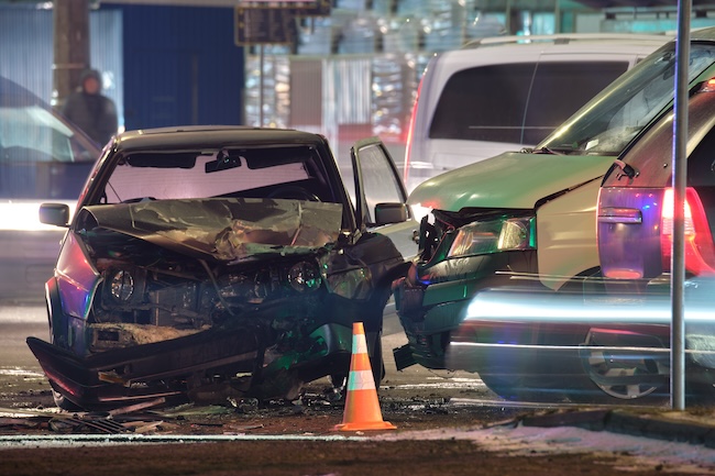 Car accident victim gripping the steering wheel in the immediate aftermath of a serious Georgia highway crash with a cracked windshield visible