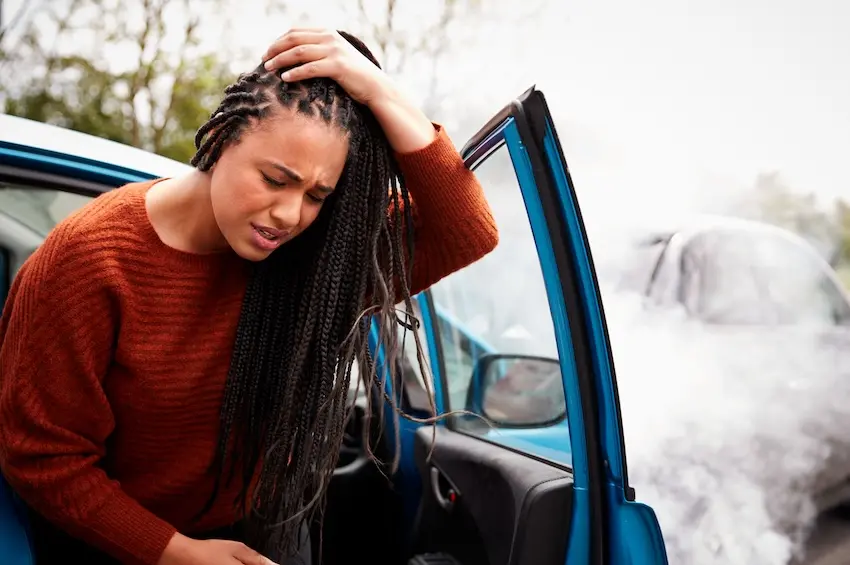 Woman experiencing headache and dizziness symptoms of concussion after car accident in Atlanta Georgia