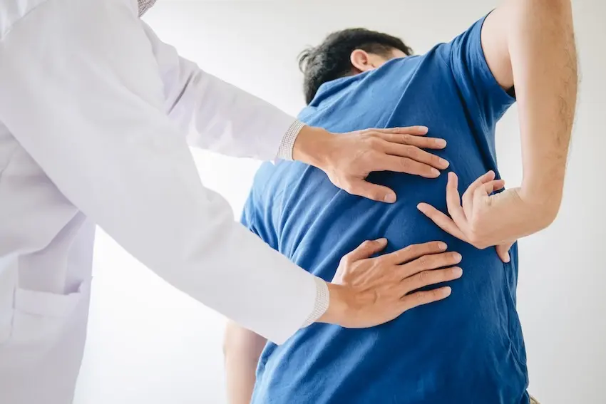 Georgia car accident victim receiving medical evaluation for delayed back pain after crash