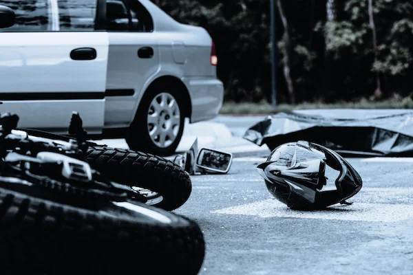 motorcycle crash scene with a helmet on the street